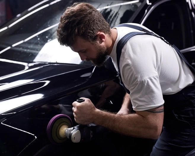 Man polishing a car with a polisher